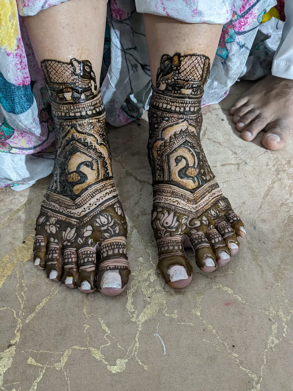 Bridal feet henna with dense jaali patterns and hidden initials