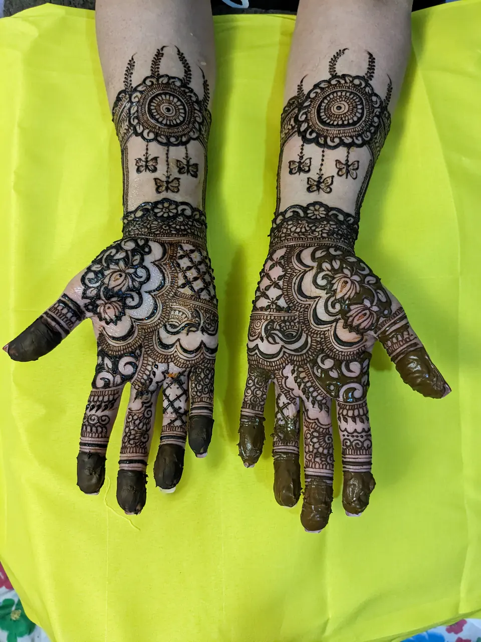 Half-arm bridal mehndi with mandalas and floral palms