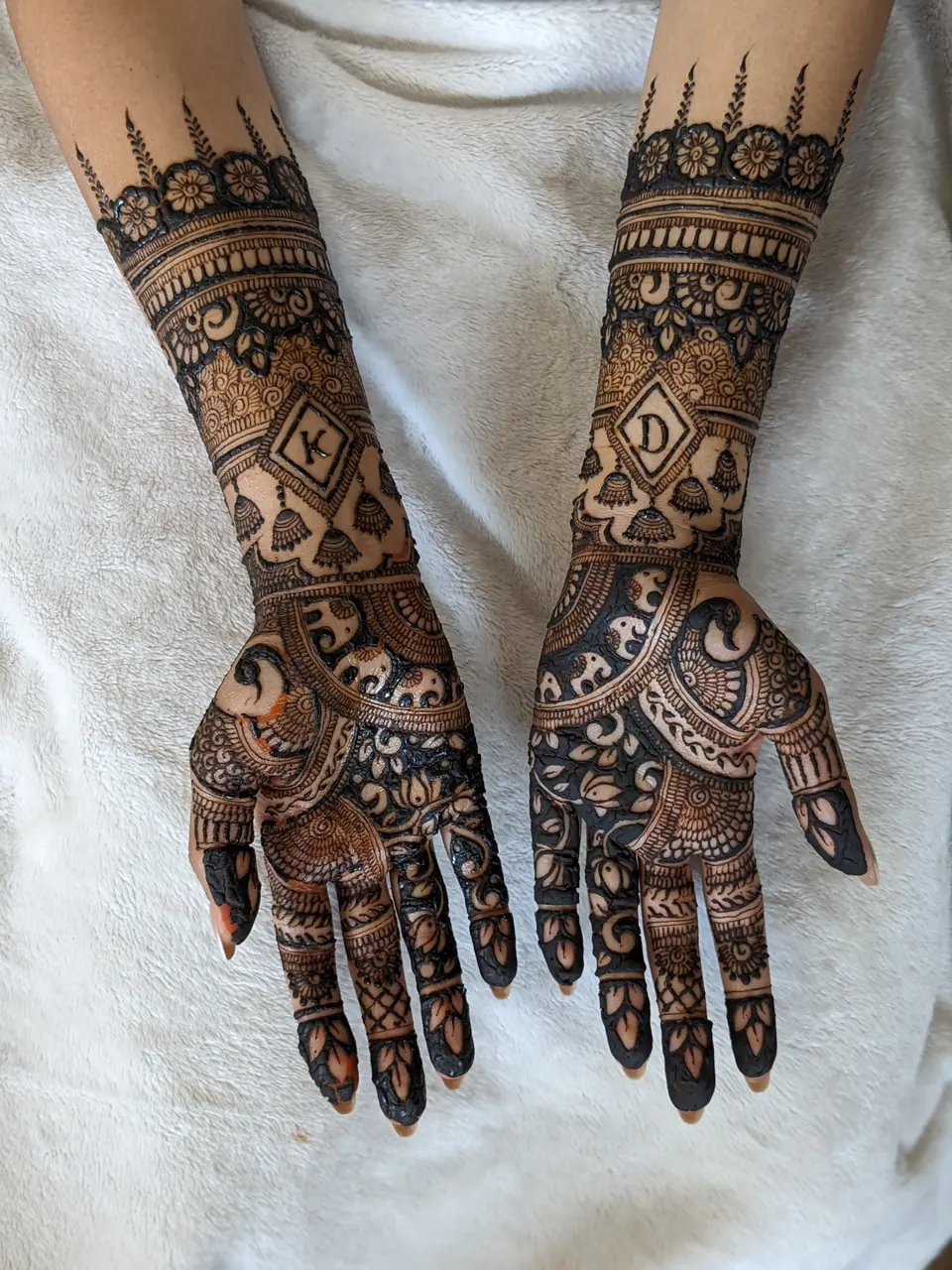 Bridal mehndi with personalised initials and playing-card motifs