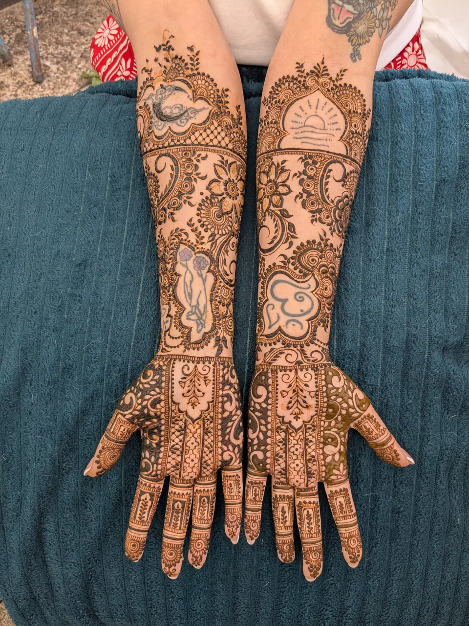 Fresh orange henna stain with peacock and sunrise motifs