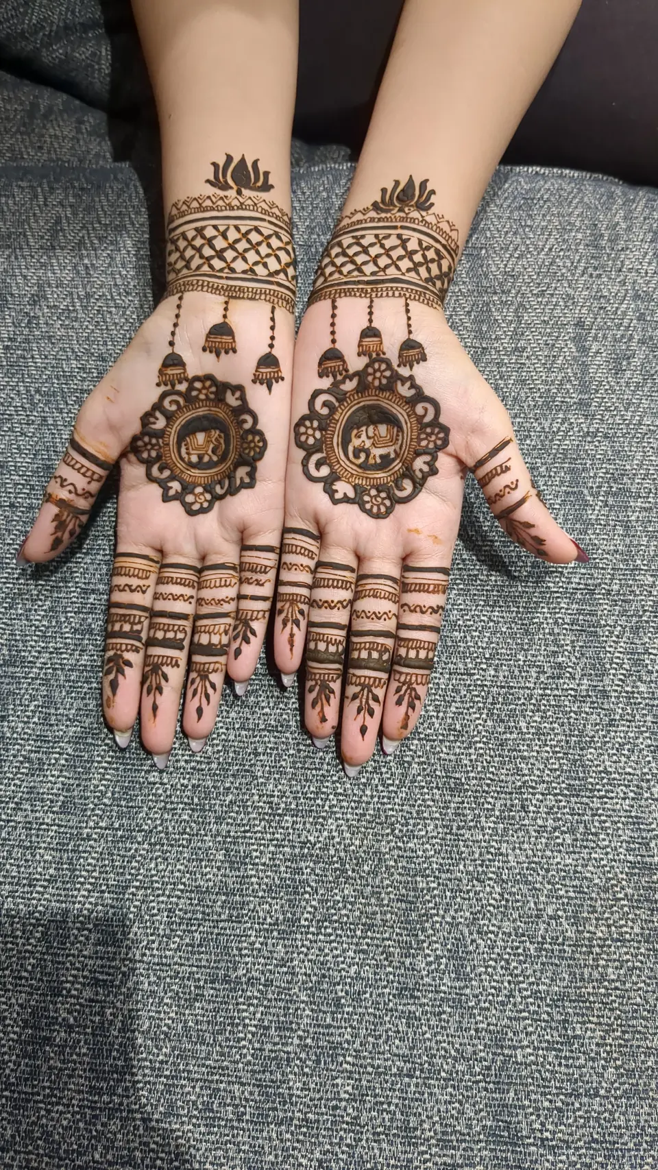 Palm mehndi with a mandala and jhumka earring motifs