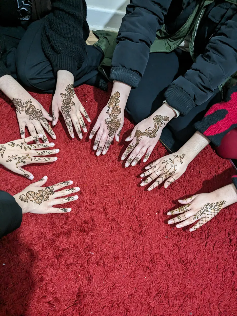 Party guests showing their henna together