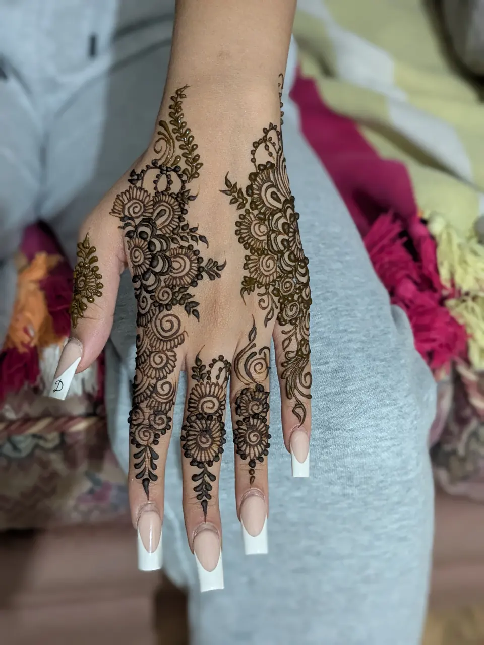 Bold floral Arabic mehndi on the back of the hand